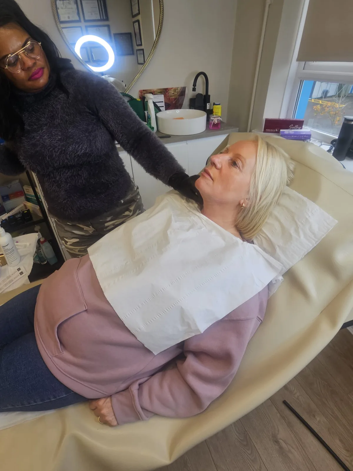 Practitioner with client preparing for intramuscular injection